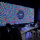 Visitors are adding vials of DNA to actual e. coli bacteria to engineer new cells, and the colored petri dishes visualize the experiment in real-time. Image: Local Projects